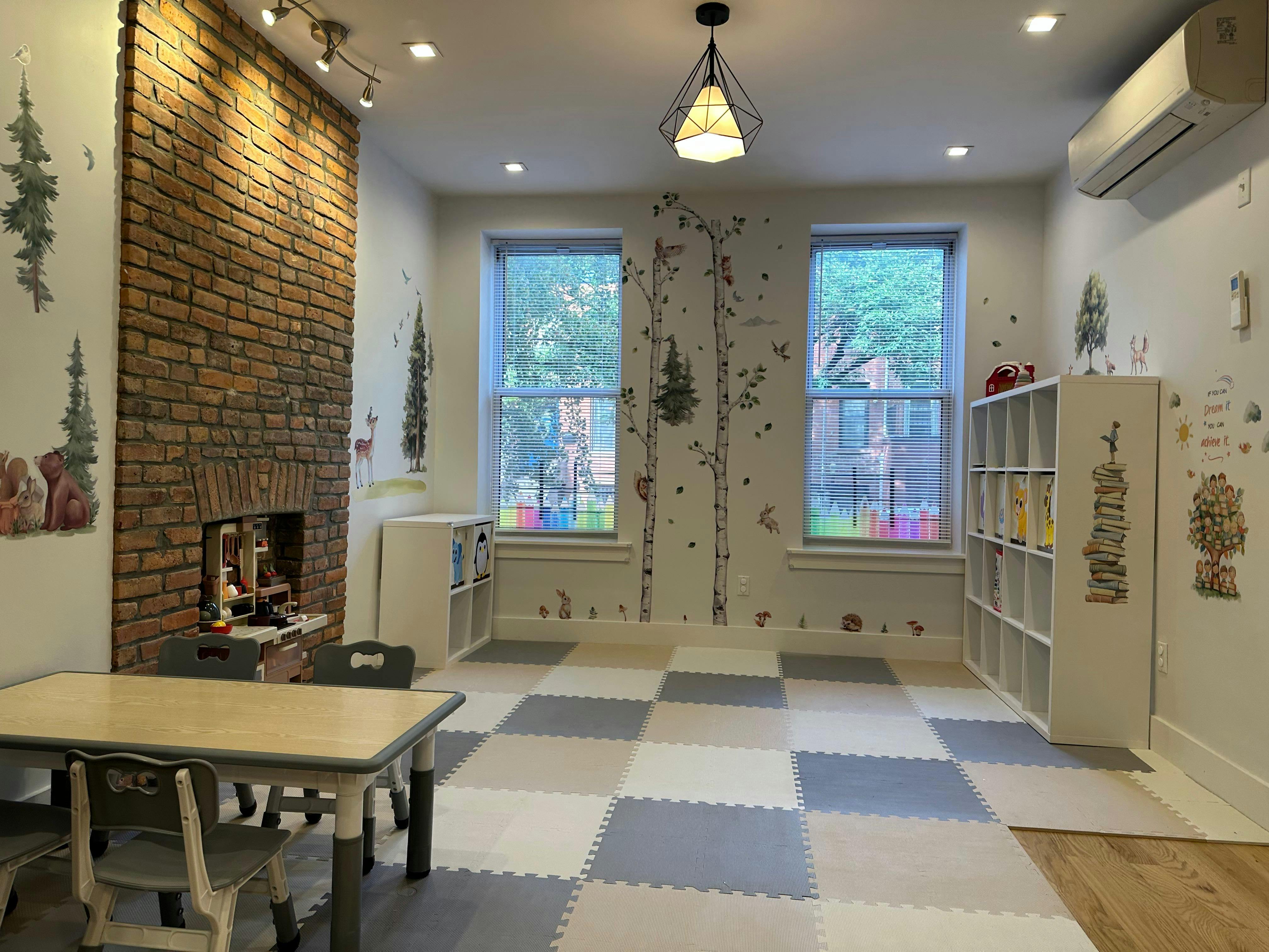 Playroom with checkered floor, brick fireplace, and two windows