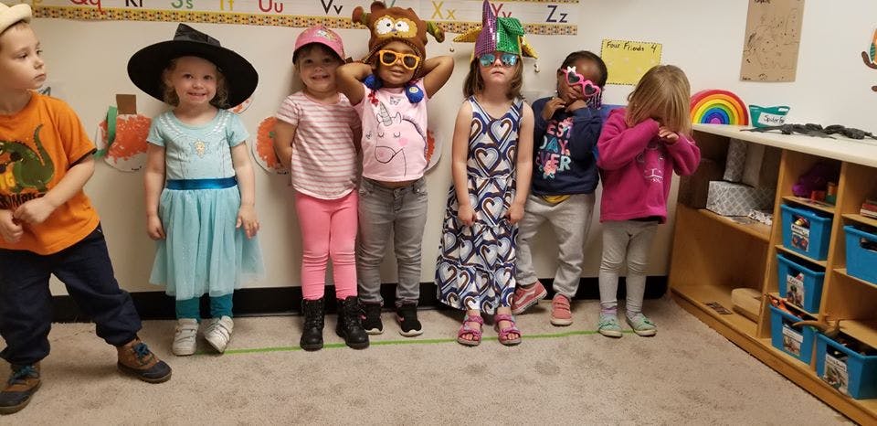 Group of children in costumes standing in a line