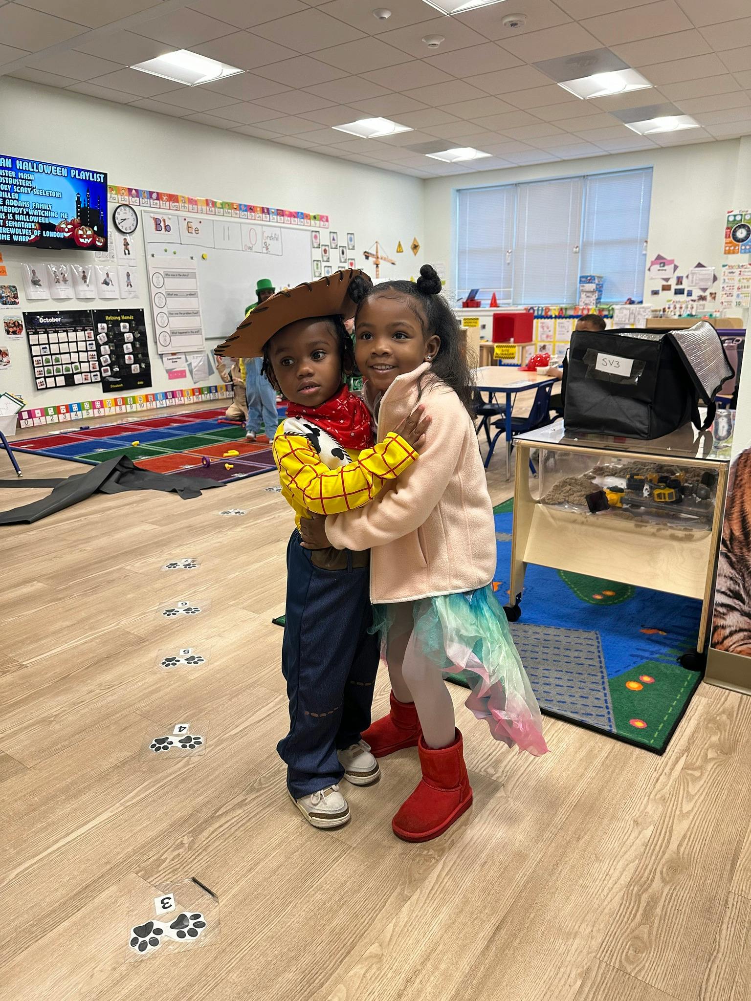 Two children hugging in a classroom