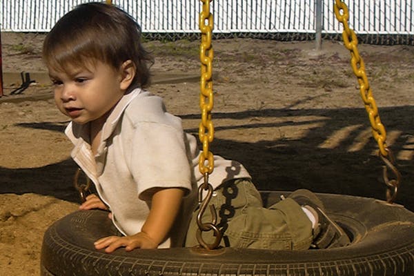Child in a tire swing