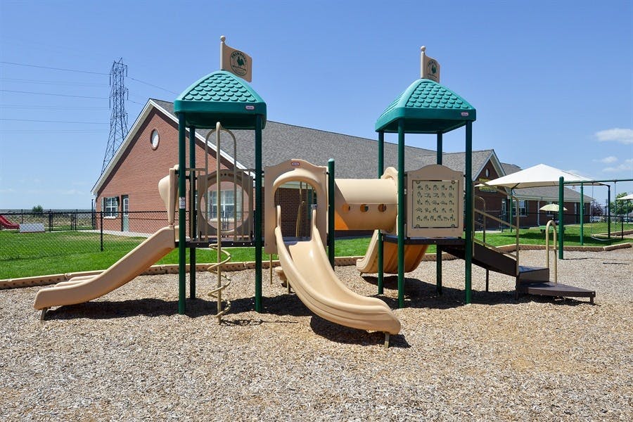 Playground with slides and climbing structures on wood chips