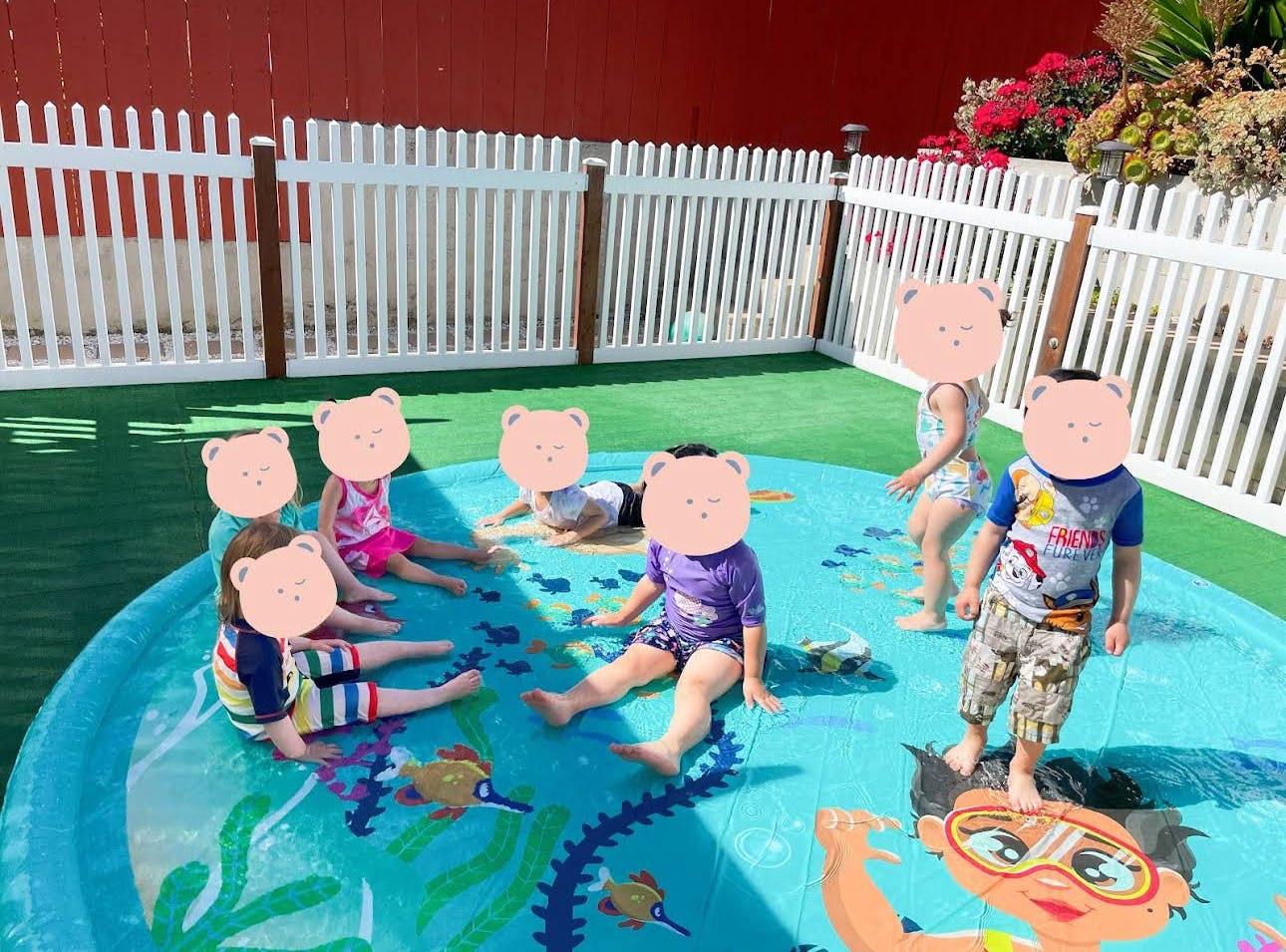 Children playing in a shallow inflatable pool