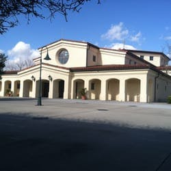 Building with arched entryway and round window