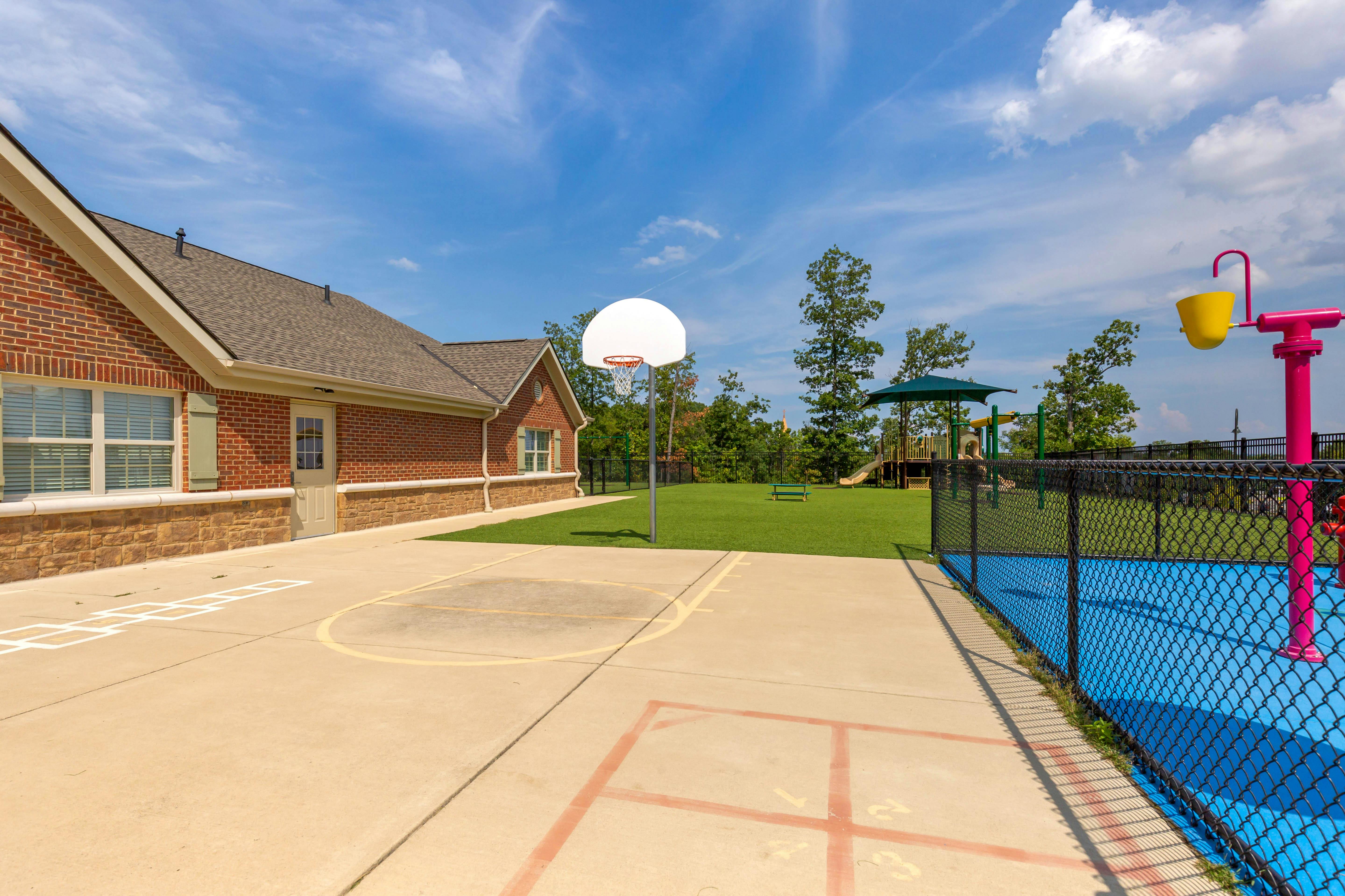 Basketball hoop on a concrete court with a hopscotch outline