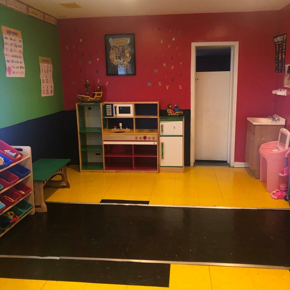 Play kitchen set in a room with red and green walls