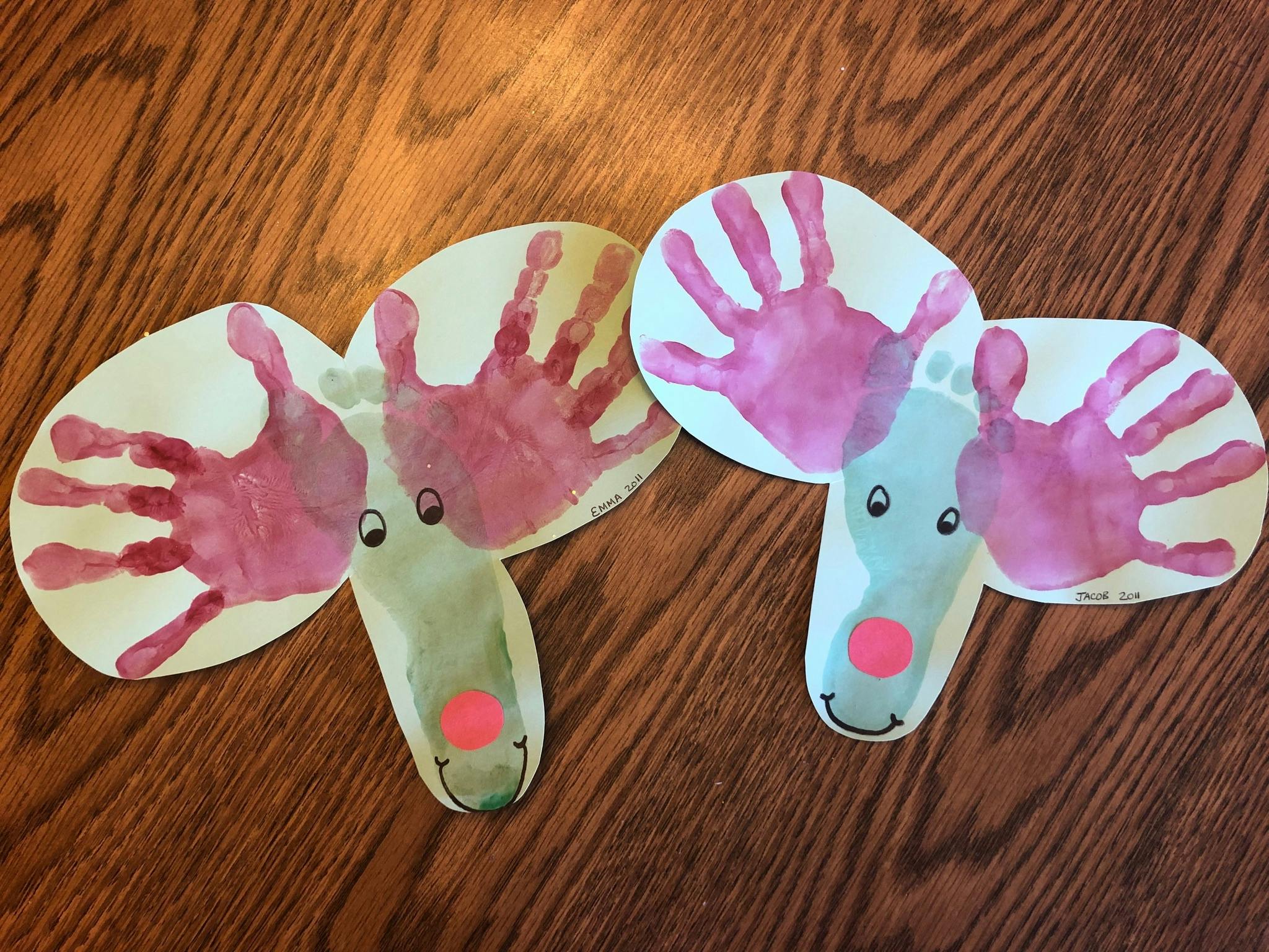 Two reindeer crafts made from children handprints and footprints