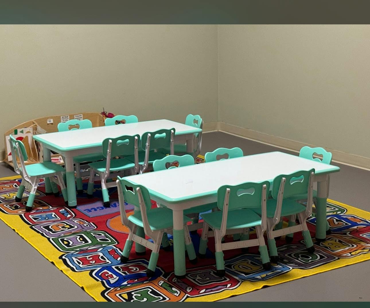 Two small tables with chairs in a classroom