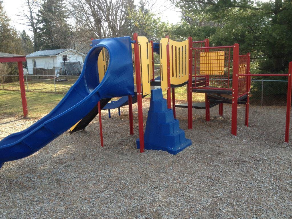Playground with blue slide and red and yellow climbing structure