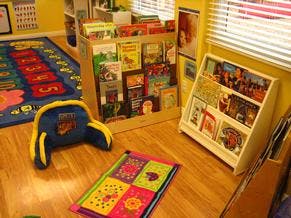 Children's classroom with book displays and colorful rugs