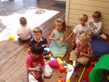 Children playing with toys on a wooden floor