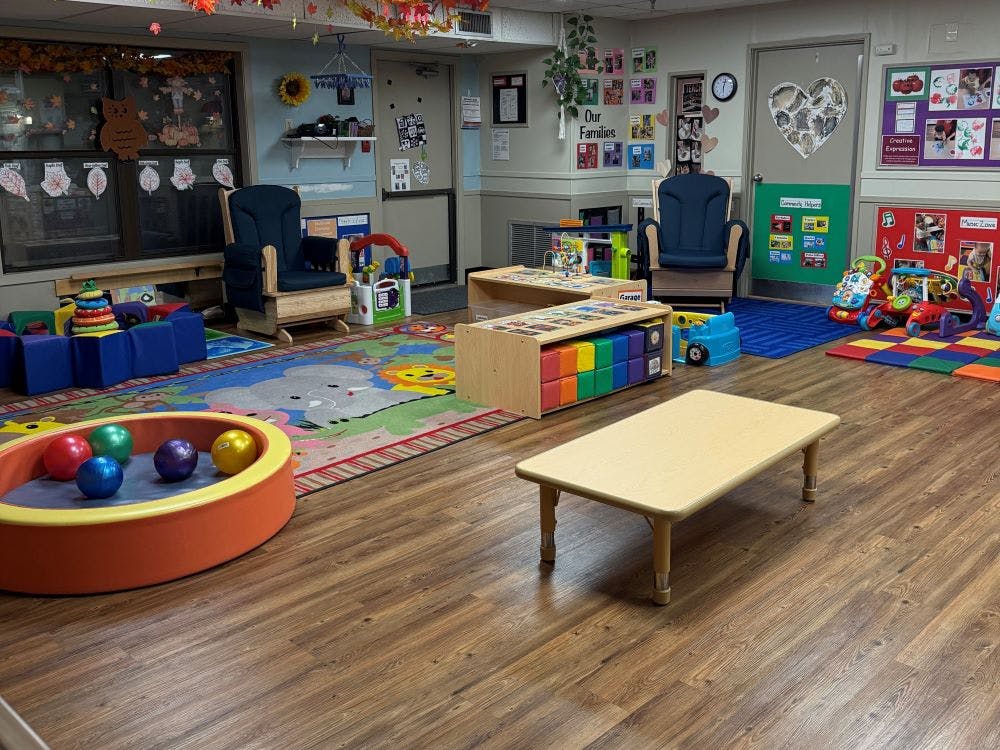 Child care classroom with chairs, play areas, and tables