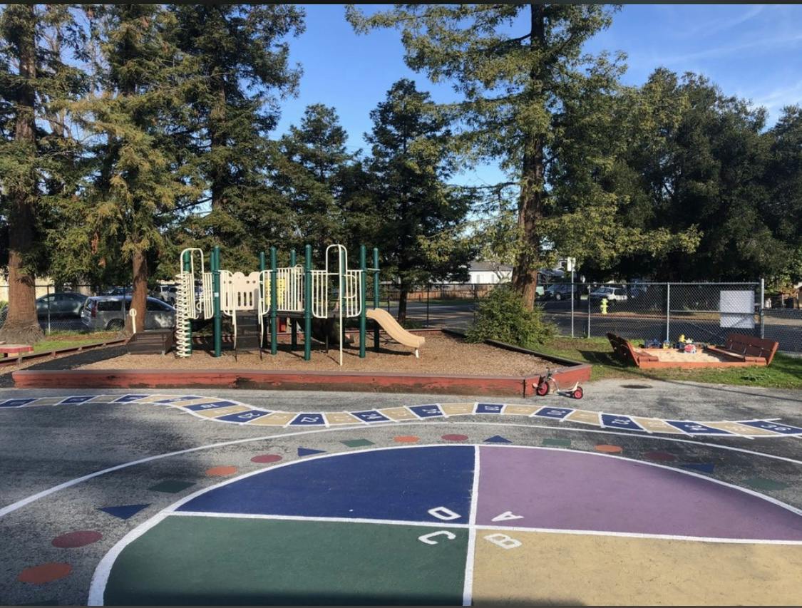 Playground with play structure, slide, and painted ground