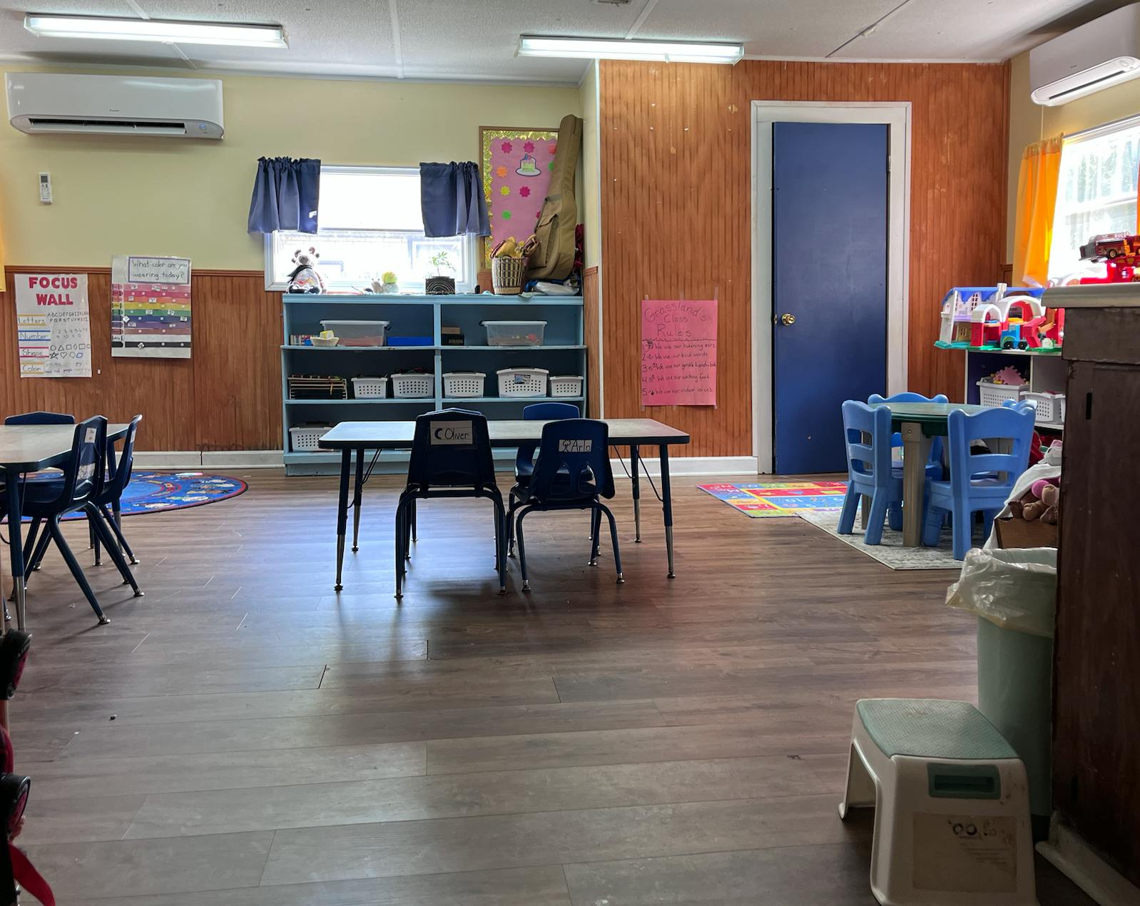 Empty classroom with small tables and chairs