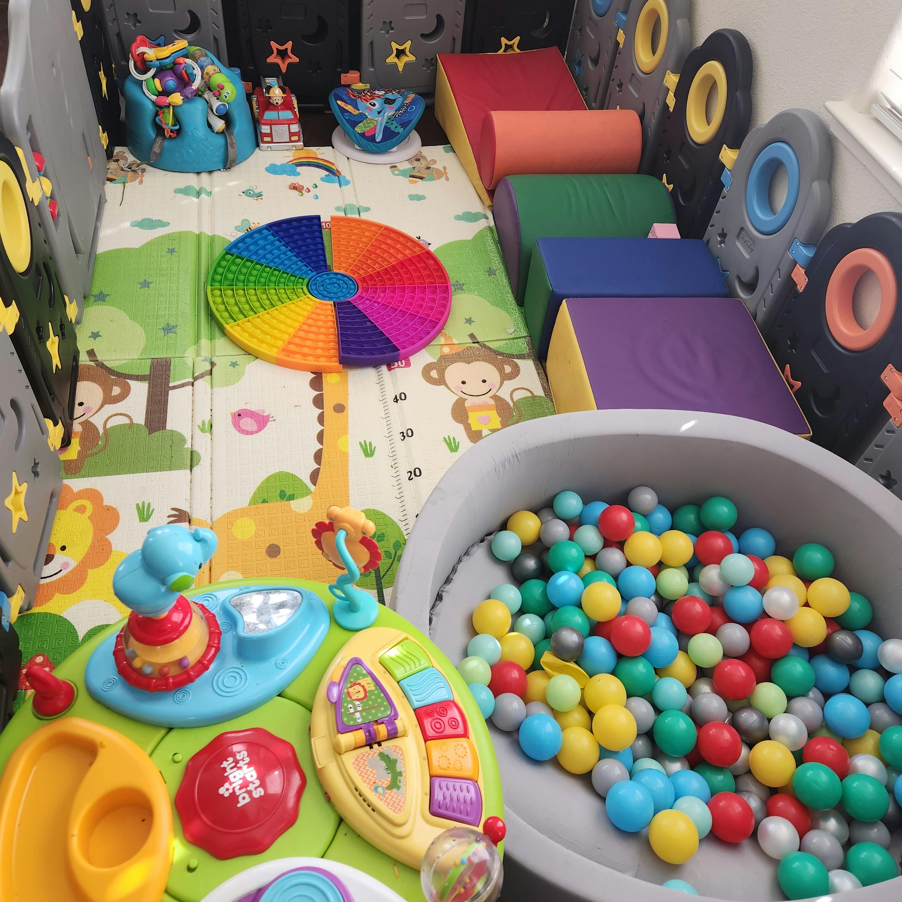 Indoor play area with soft blocks, ball pit, and activity toys