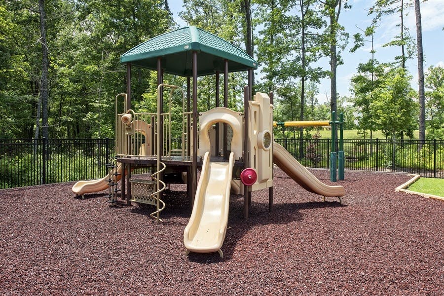 Playground with slides and climbing structures on a wood chip surface