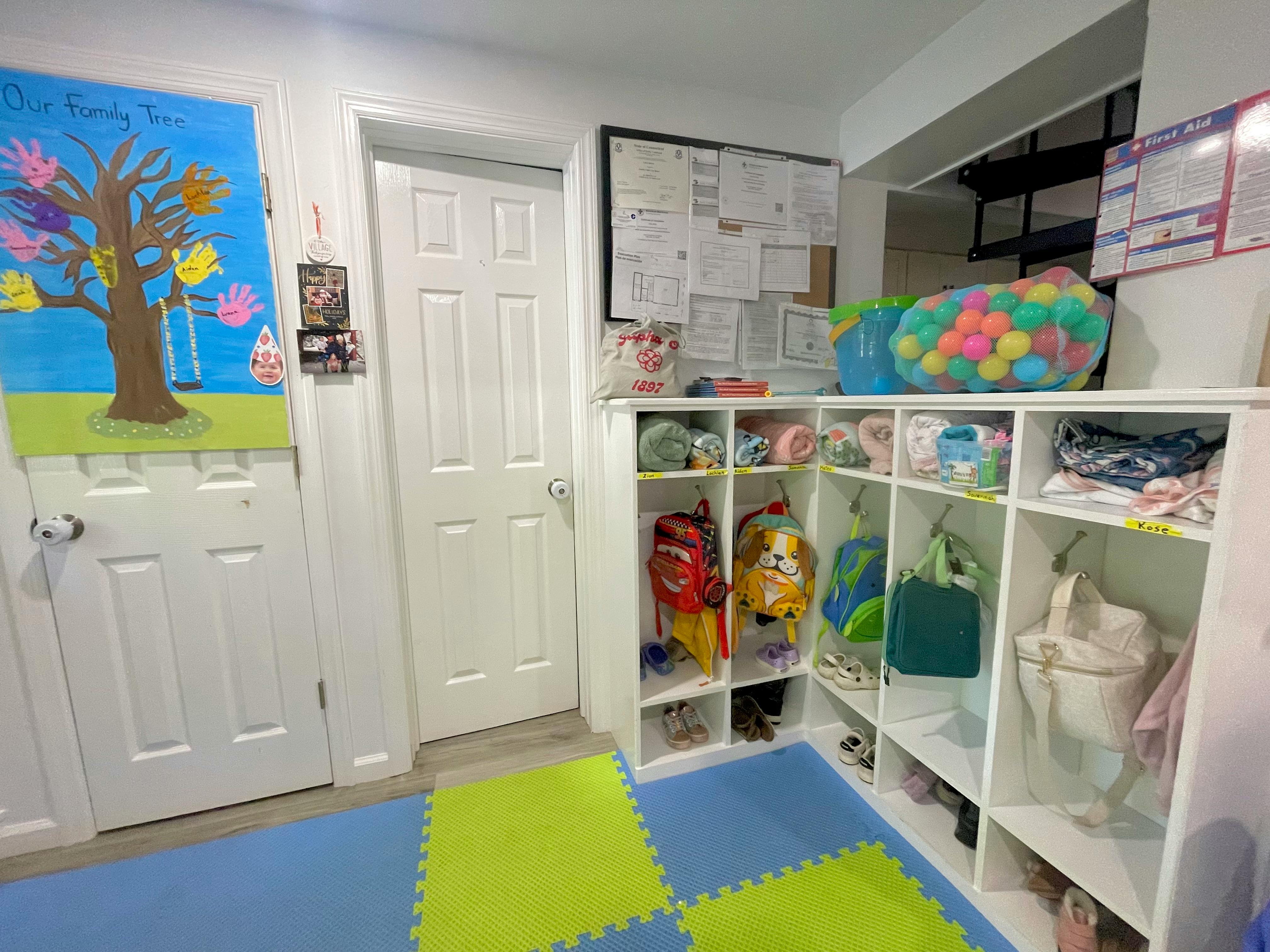 Childcare cubby storage with backpacks and labeled shelves