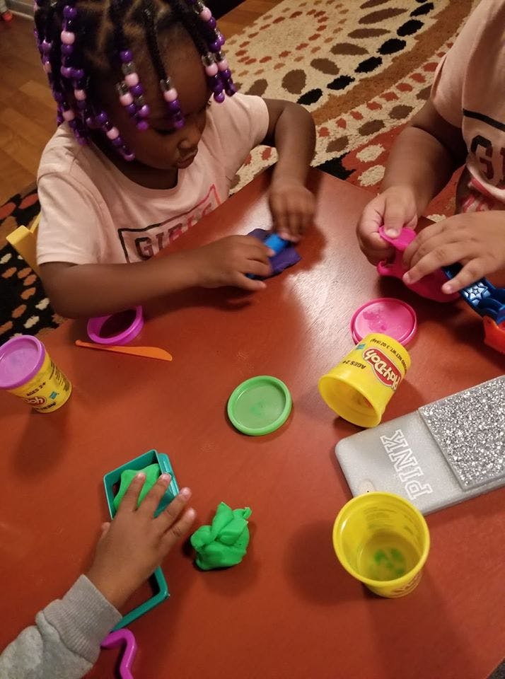 Children playing with modeling clay at a table