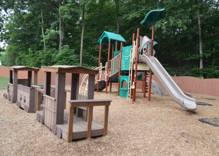 Playground with a train structure and a slide
