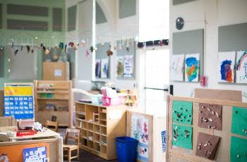 Empty classroom with children's artwork and furniture