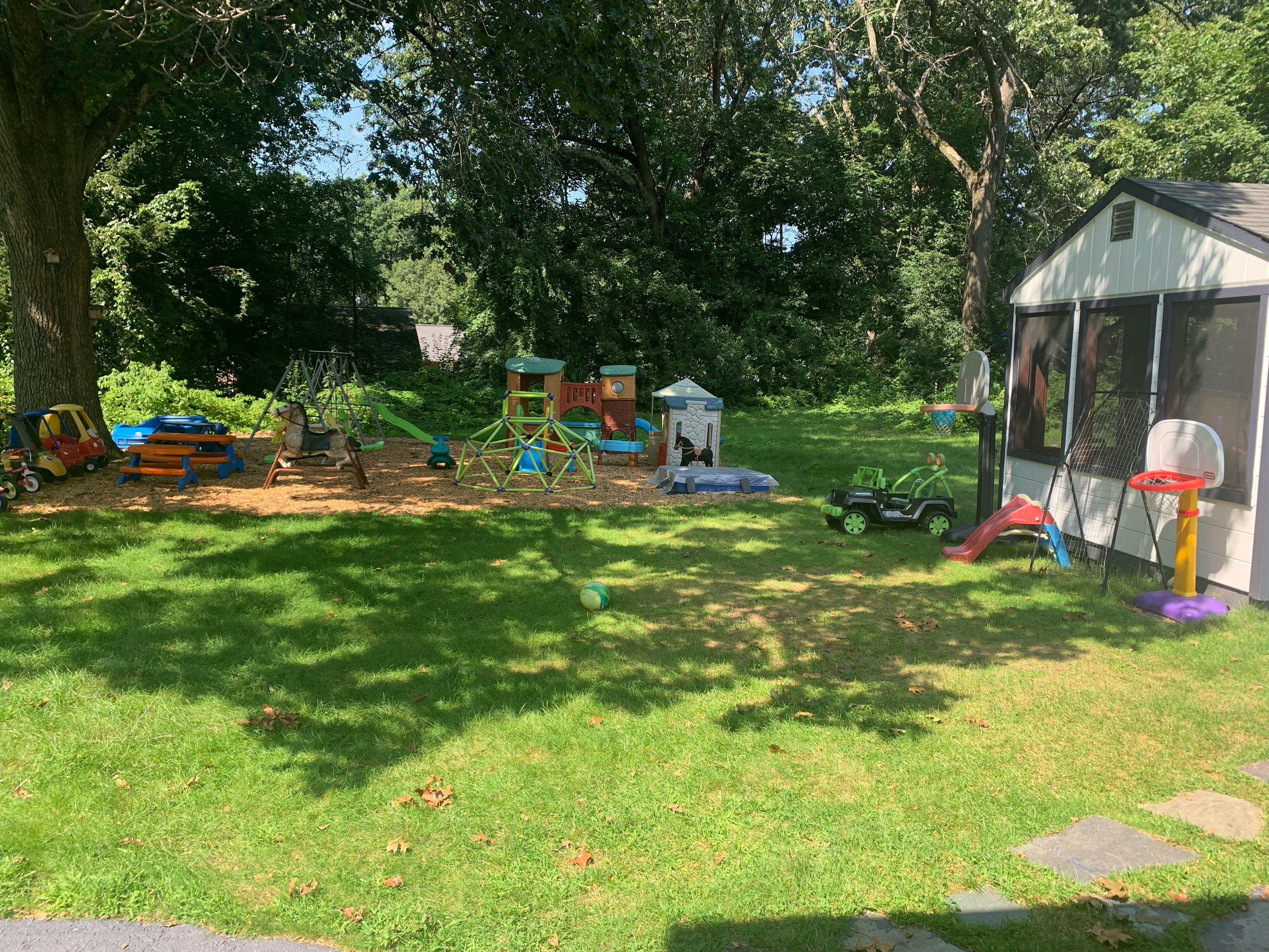 Backyard with playground equipment and a shed
