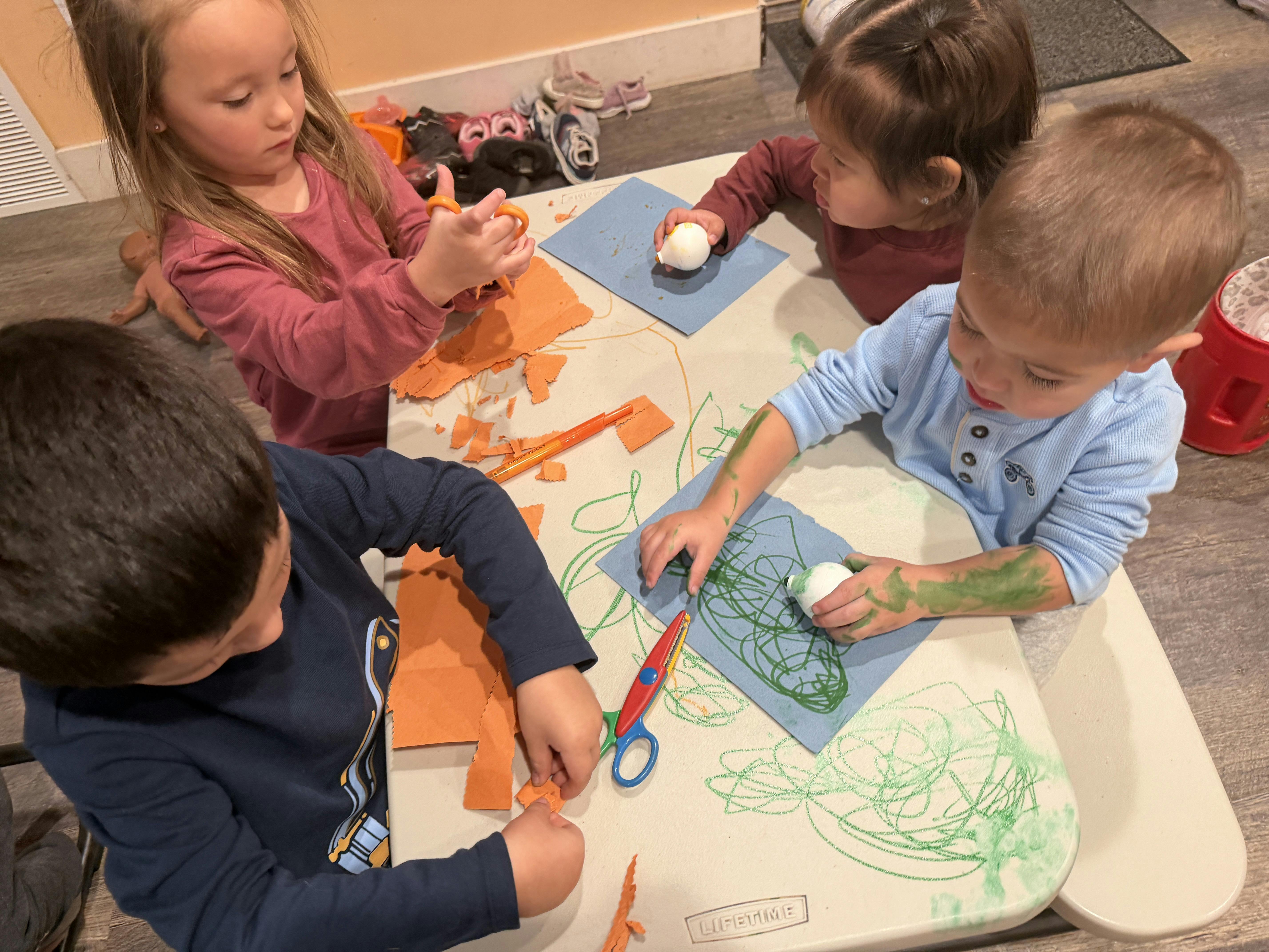 Children doing crafts at a table