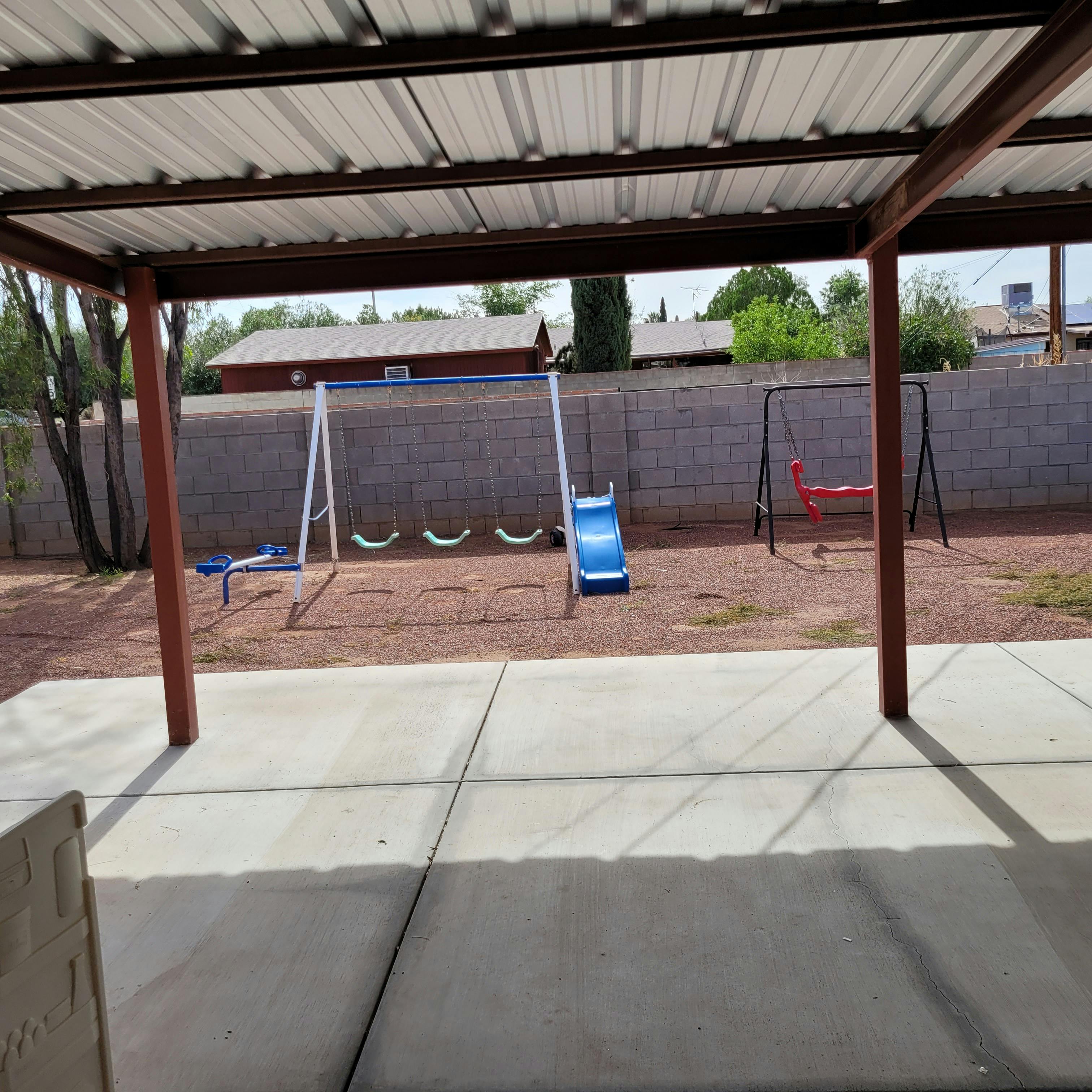 Backyard with a swing set and slide