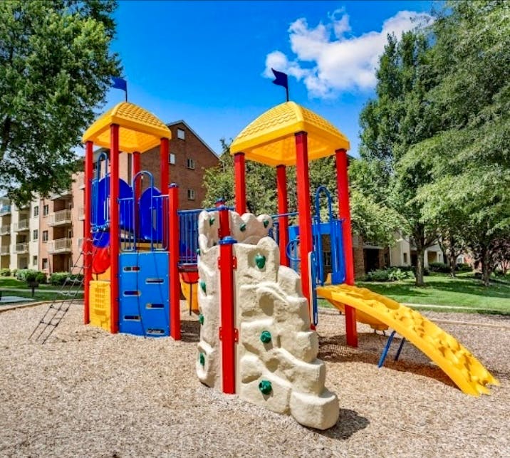Playground with slides and climbing wall on wood chips