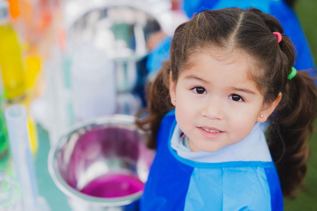 Child with pigtails looking at the camera