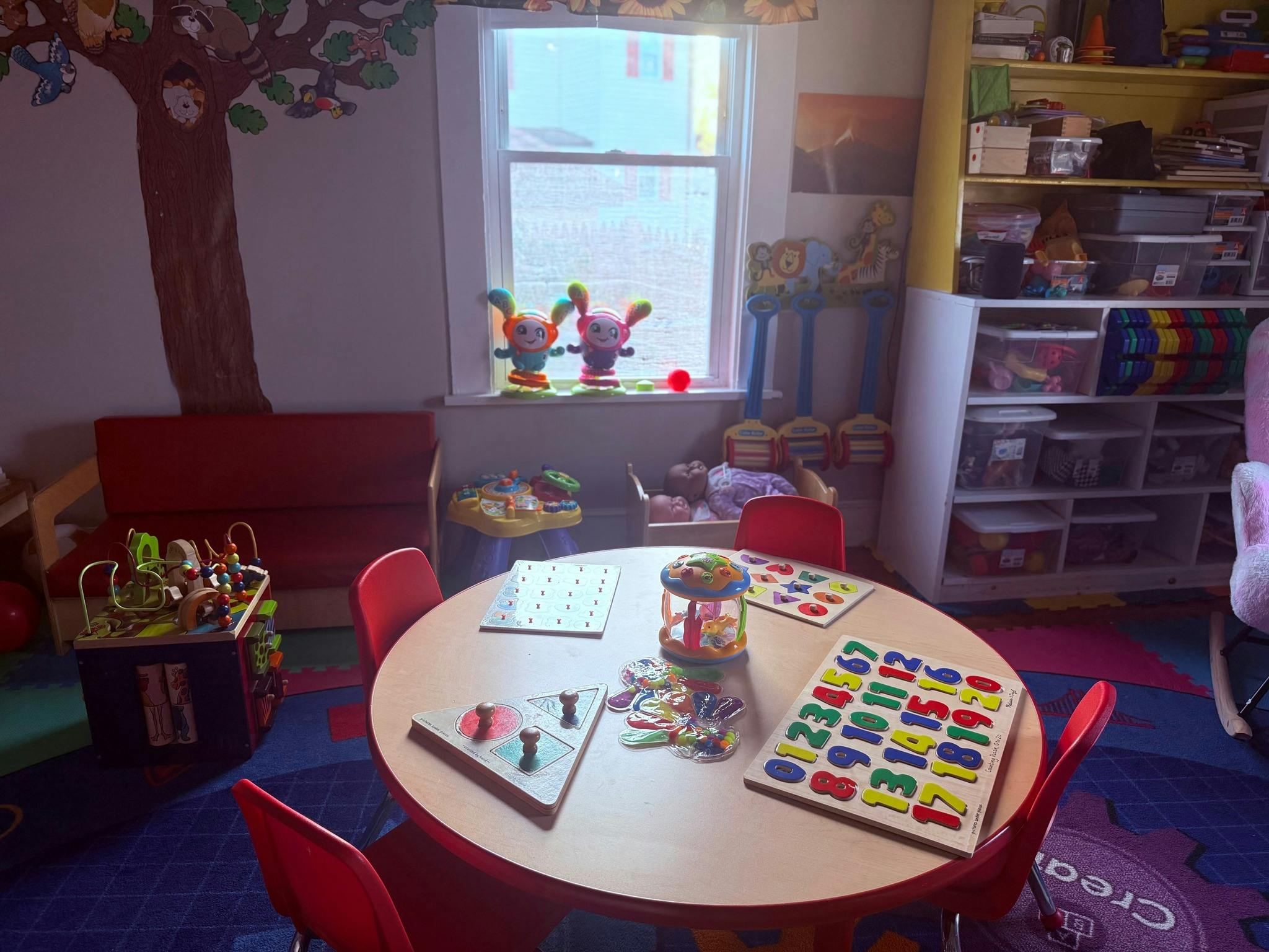 Round table with educational puzzles and toys in a child playroom