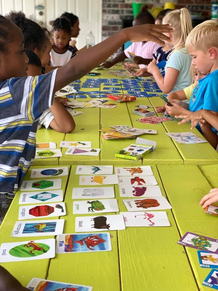 Children playing a card game at a table
