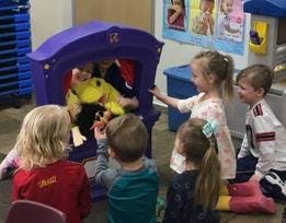Children playing with a puppet theater