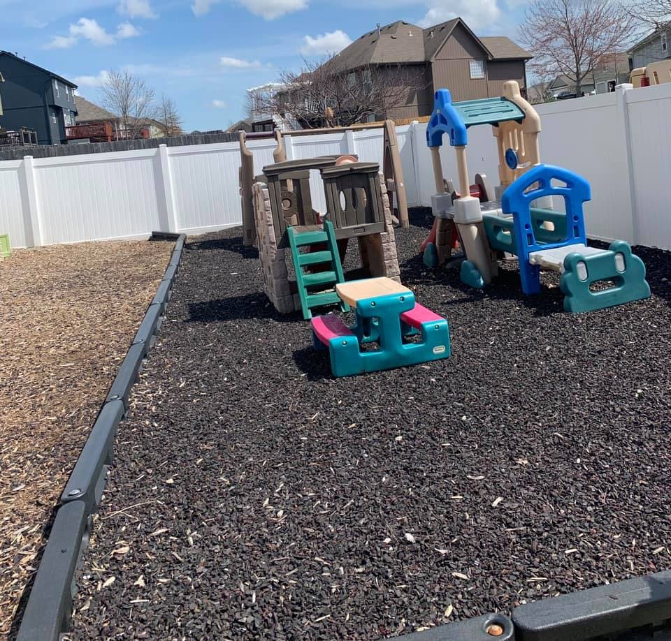 Outdoor playground with play structures and a small picnic table