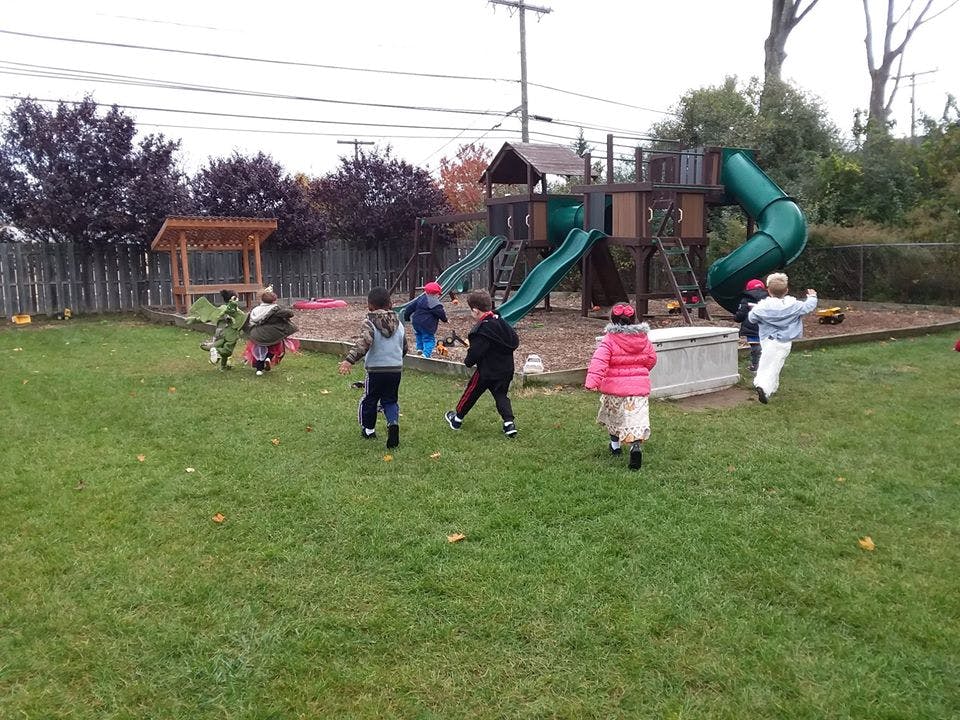 Children playing on a playground with slides and climbing structures
