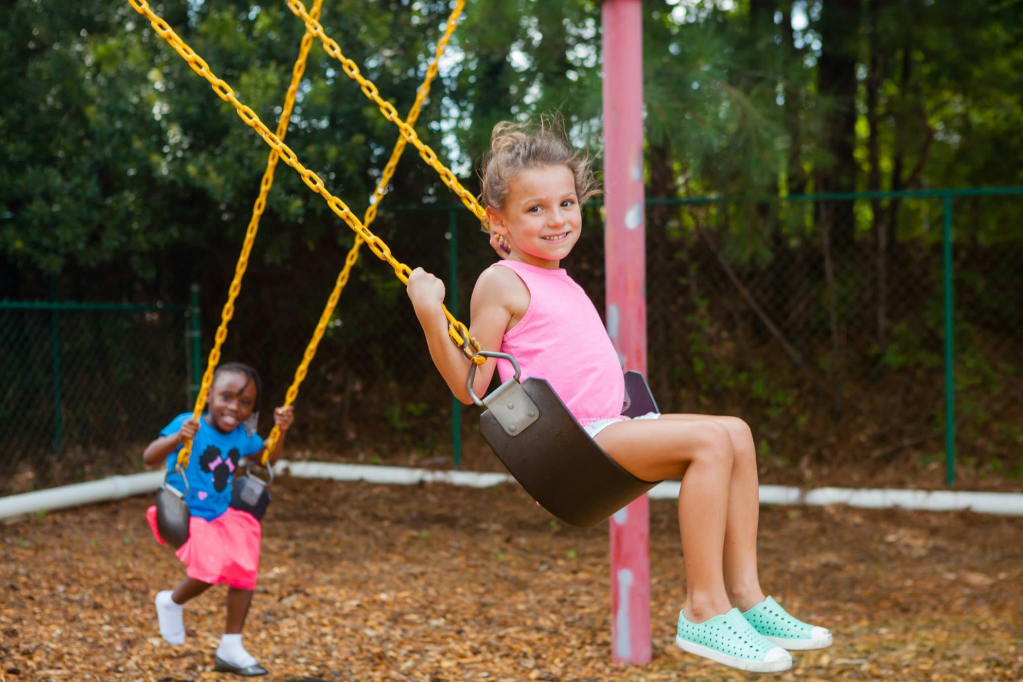 Two children on swings at a playground