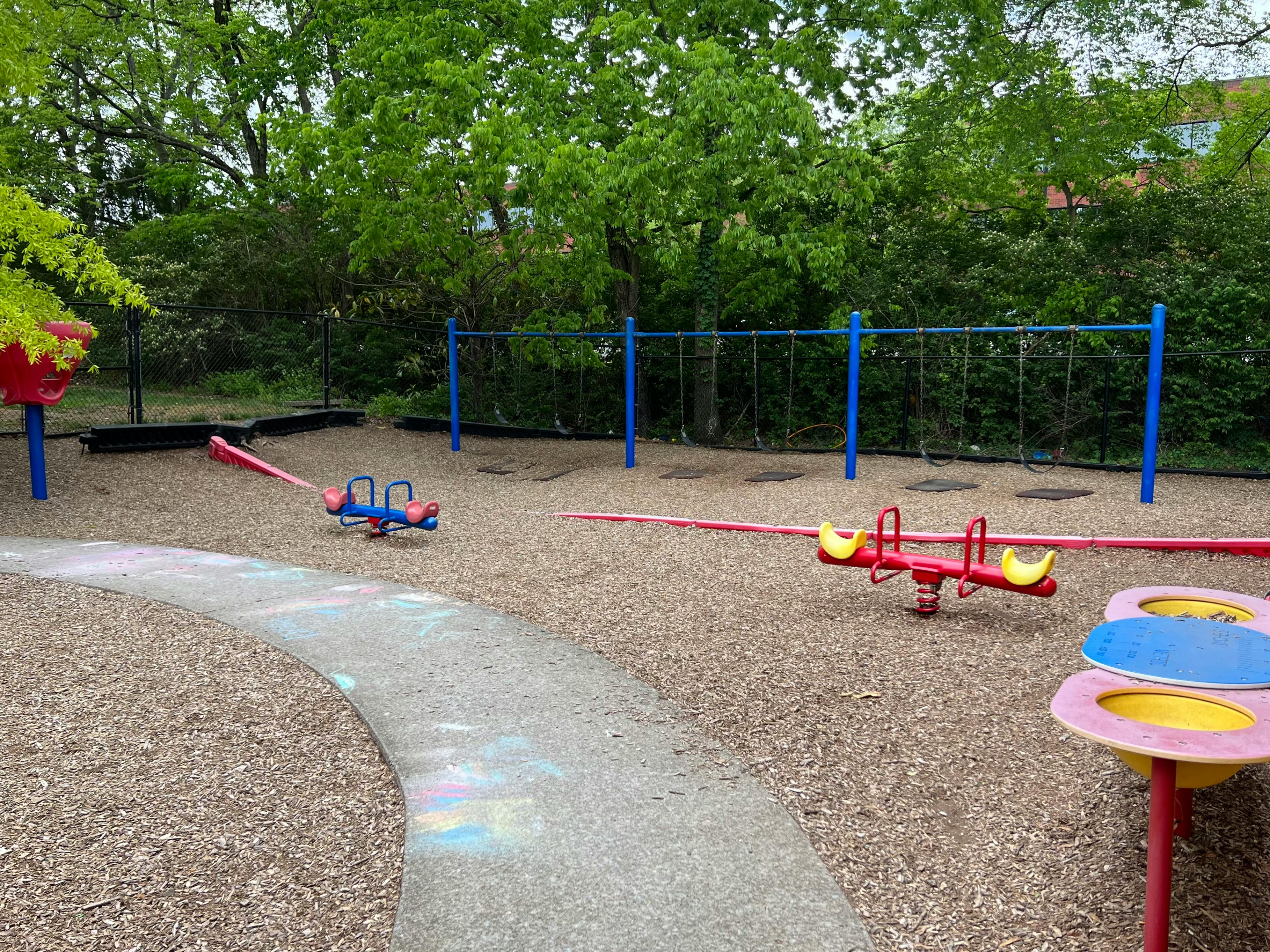 Playground with swings, seesaws, and a winding path