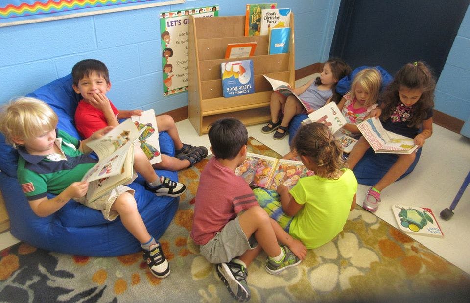Children reading books in a classroom