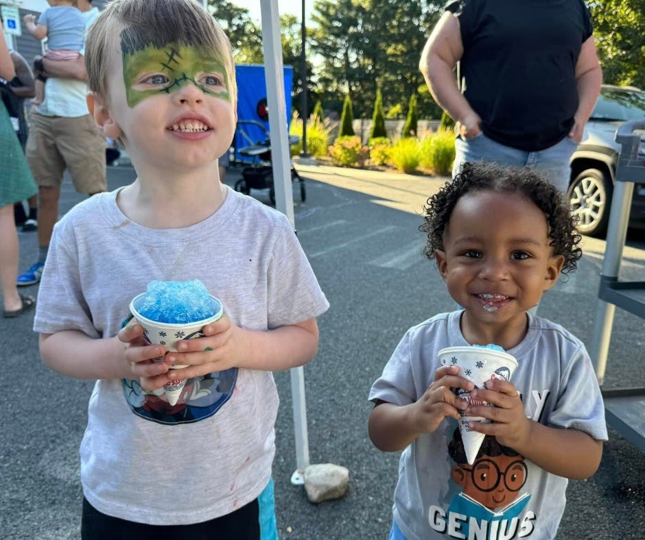Two children holding cups of shaved ice