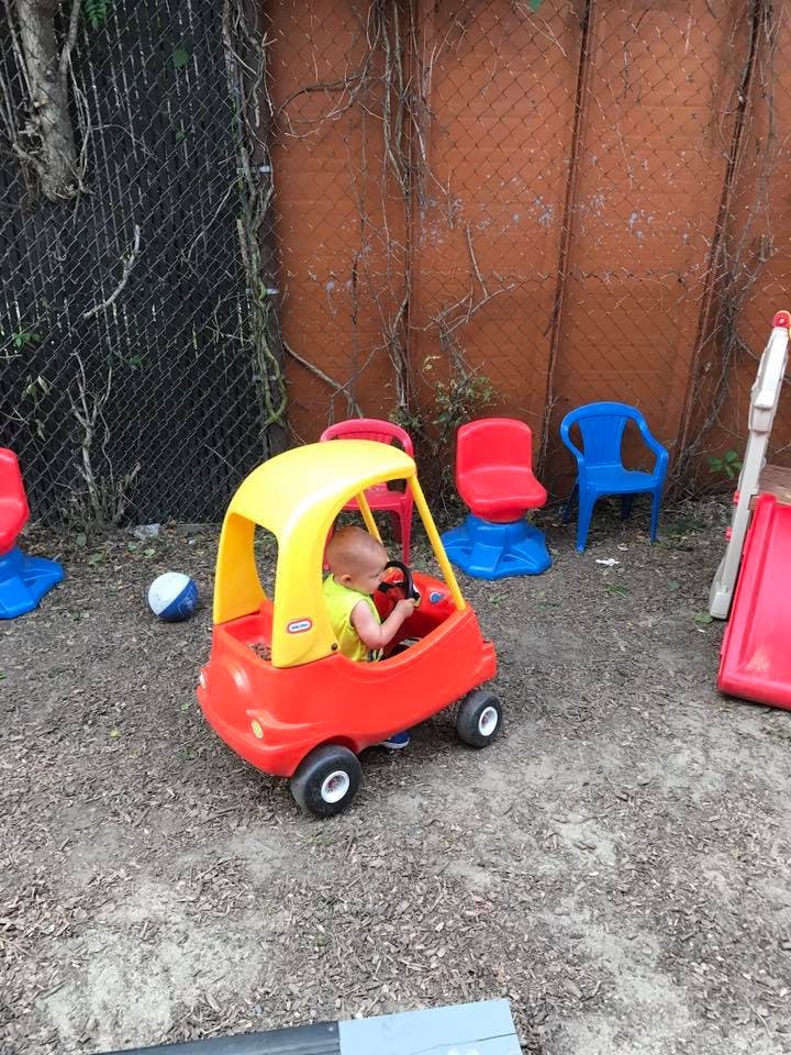 Child in a toy car