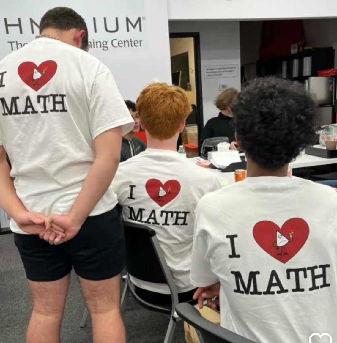 People wearing white shirts with "I love MATH" on the back