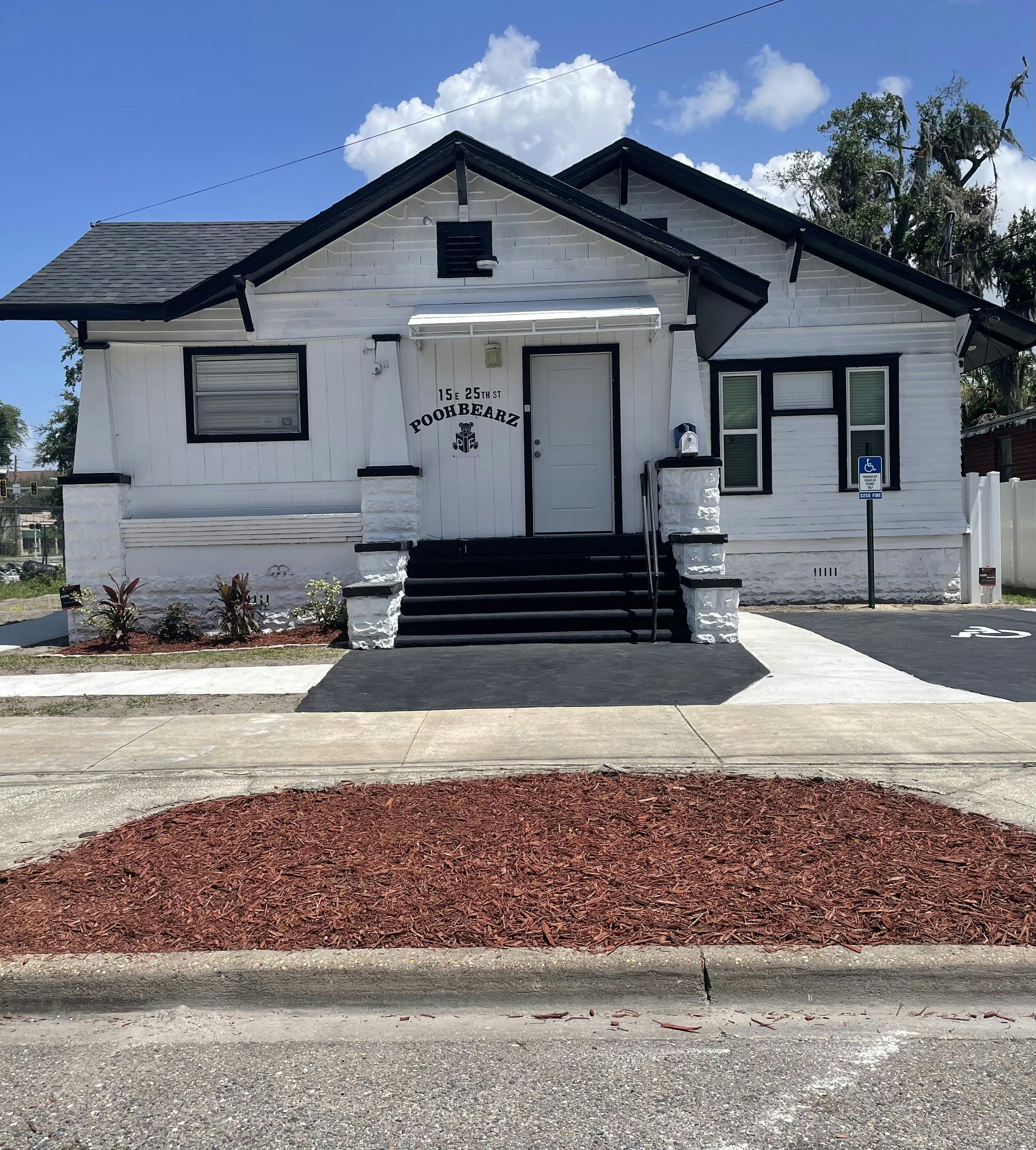 White building with Poohbearz signage and black trim