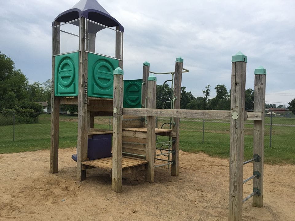 Playground structure with a tower and monkey bars