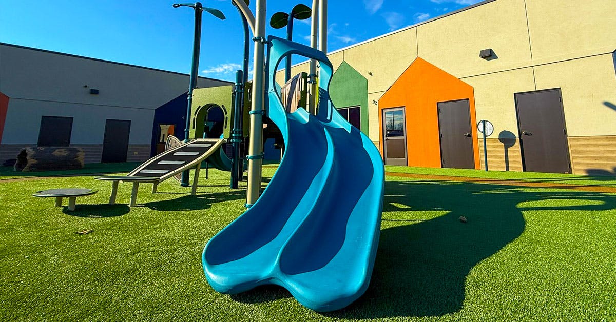 Blue slide and climbing structure on a playground