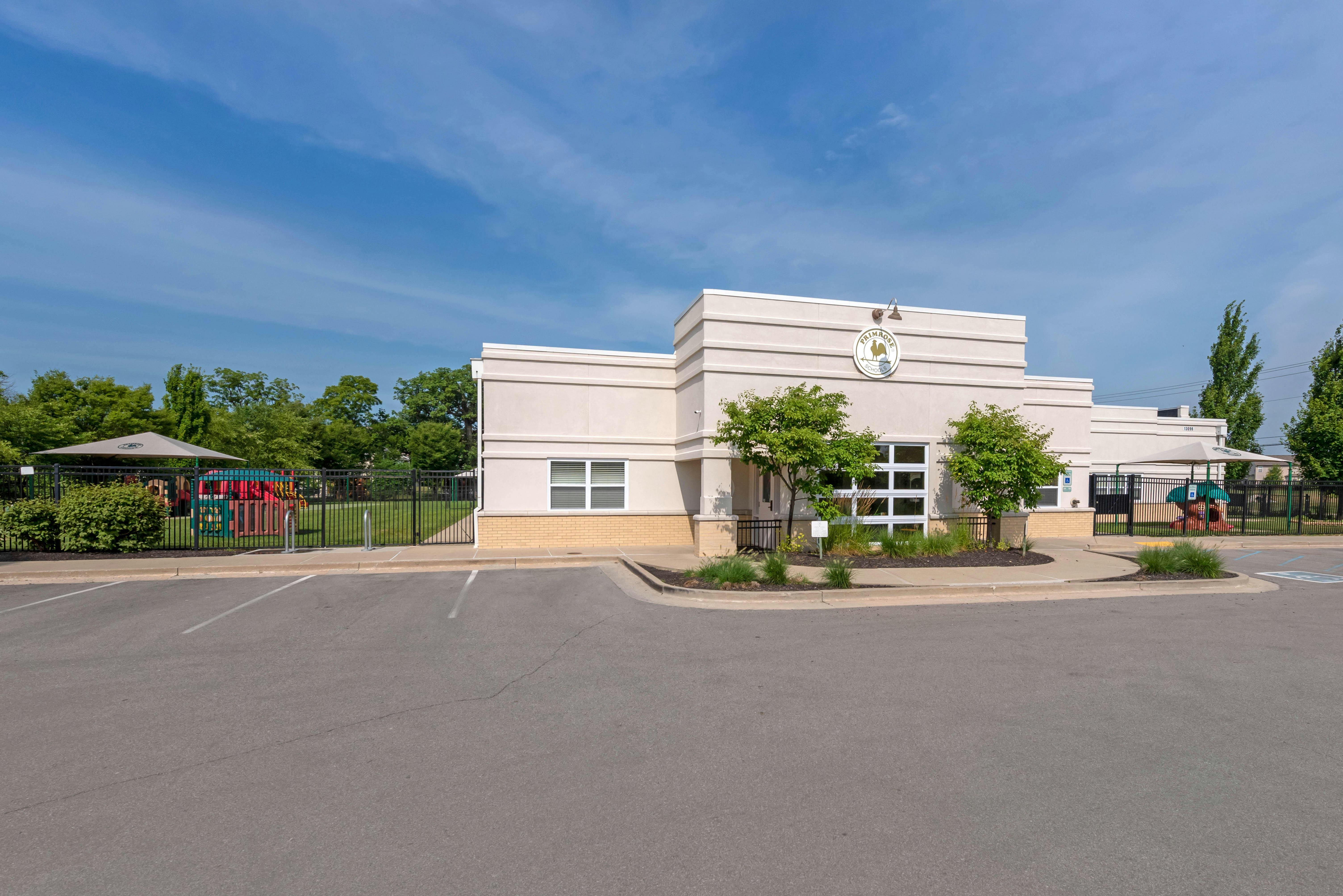Building exterior with parking lot and playground