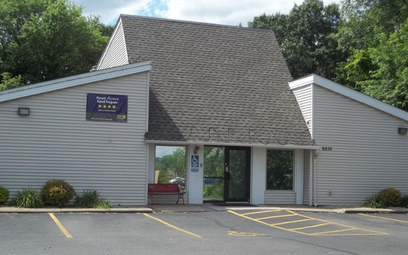 Building with a Parent Aware Rated Program sign and red bench