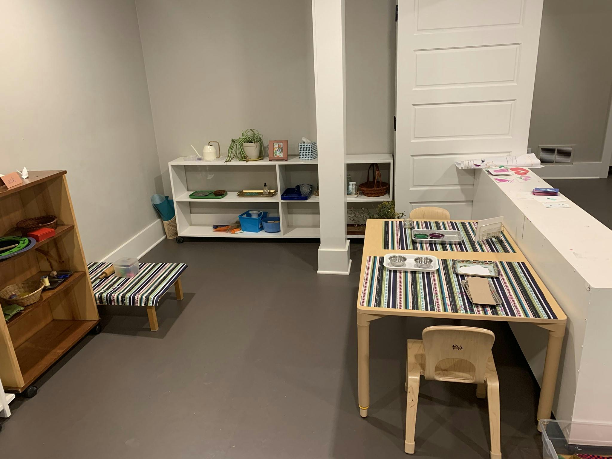 Children's play area with small tables and shelves