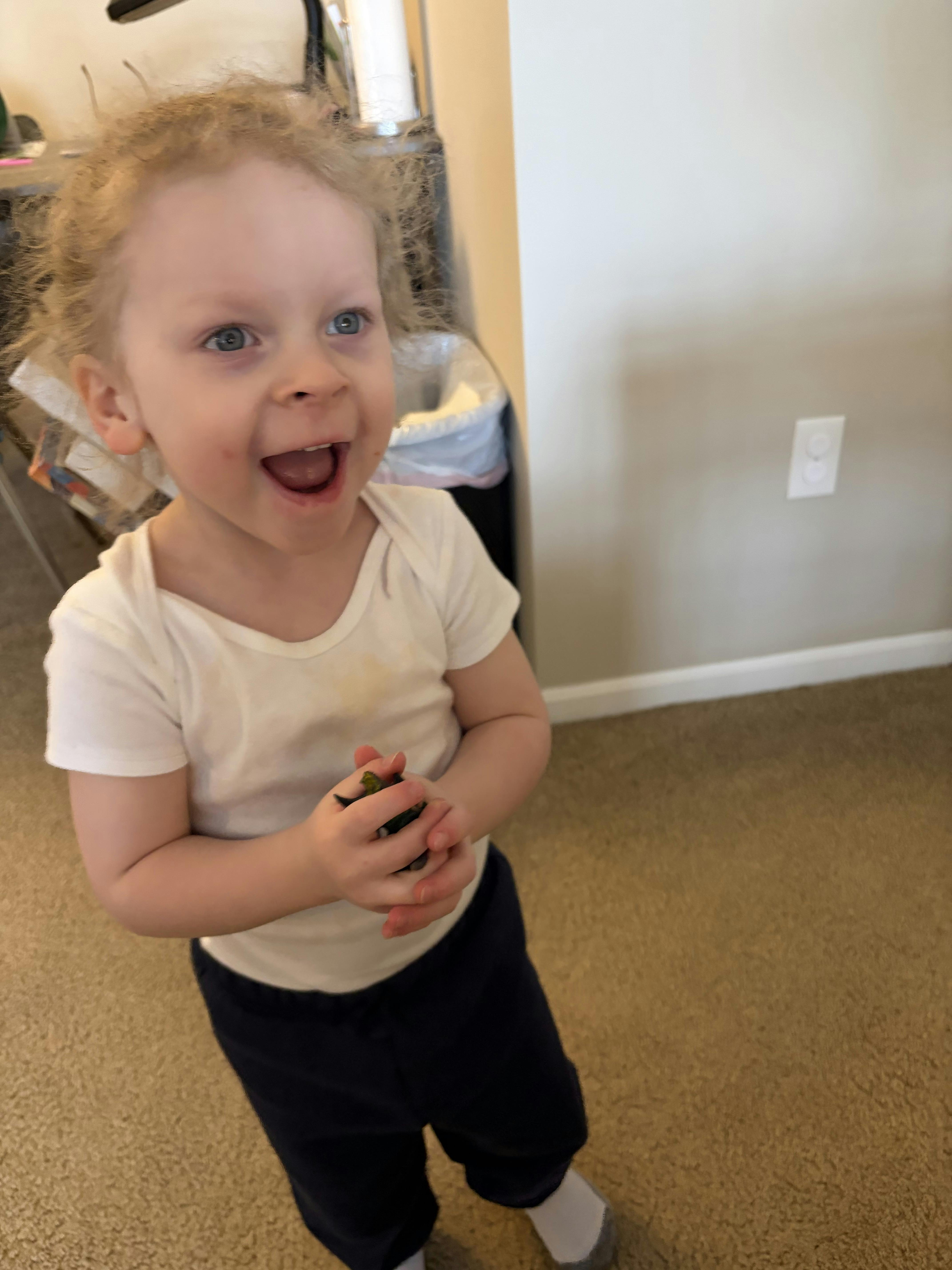 Child standing with hands held together