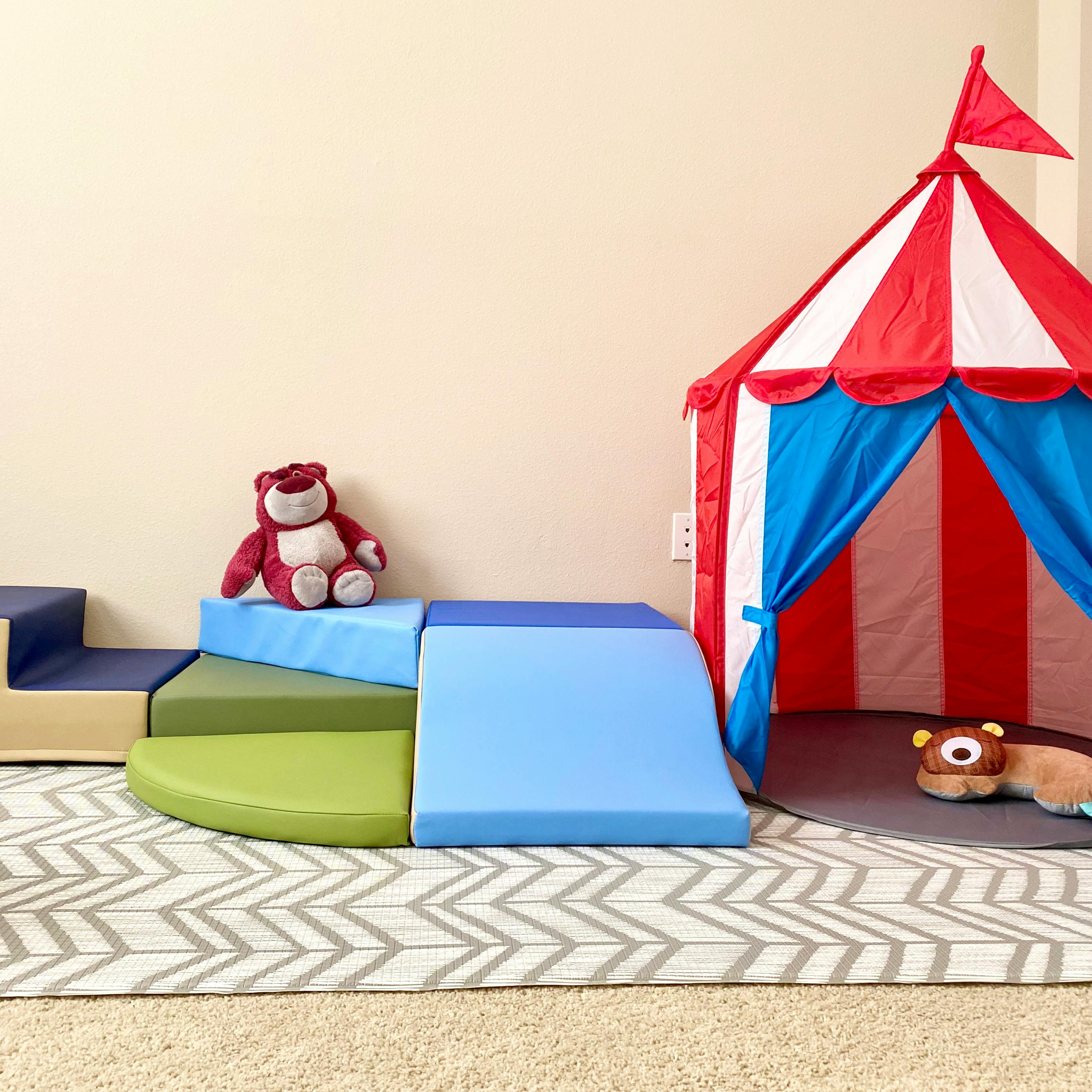 Soft play climbing blocks and a play tent in a room