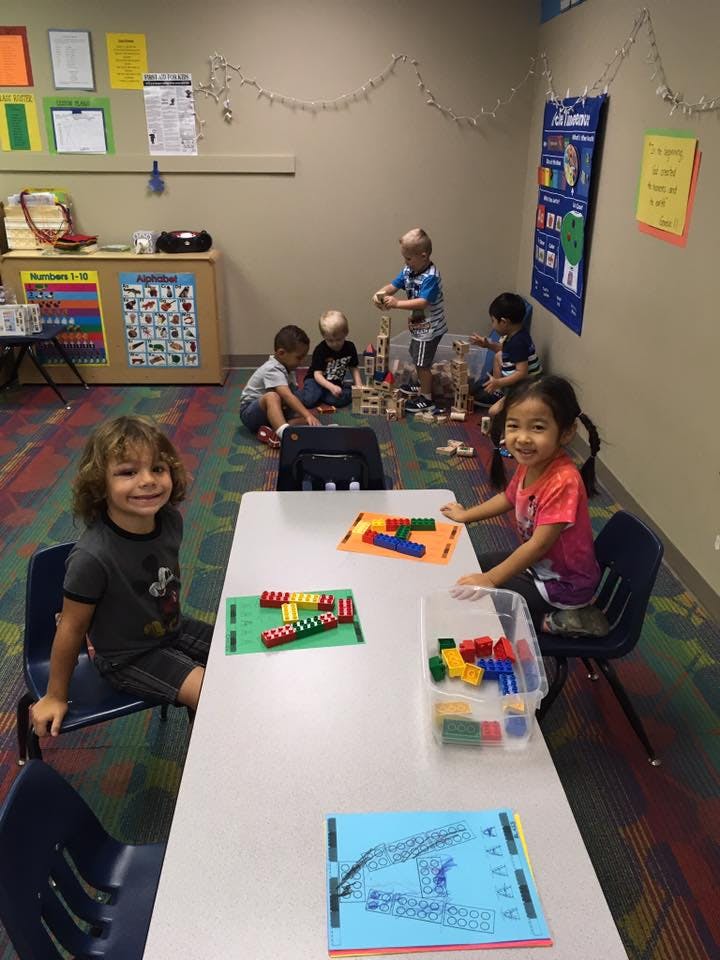 Children playing with blocks and toys in a classroom
