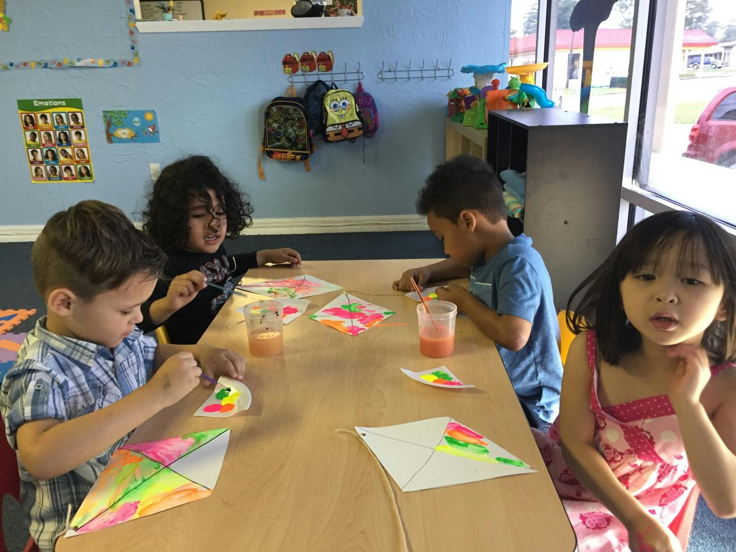 Children sitting at a table doing crafts