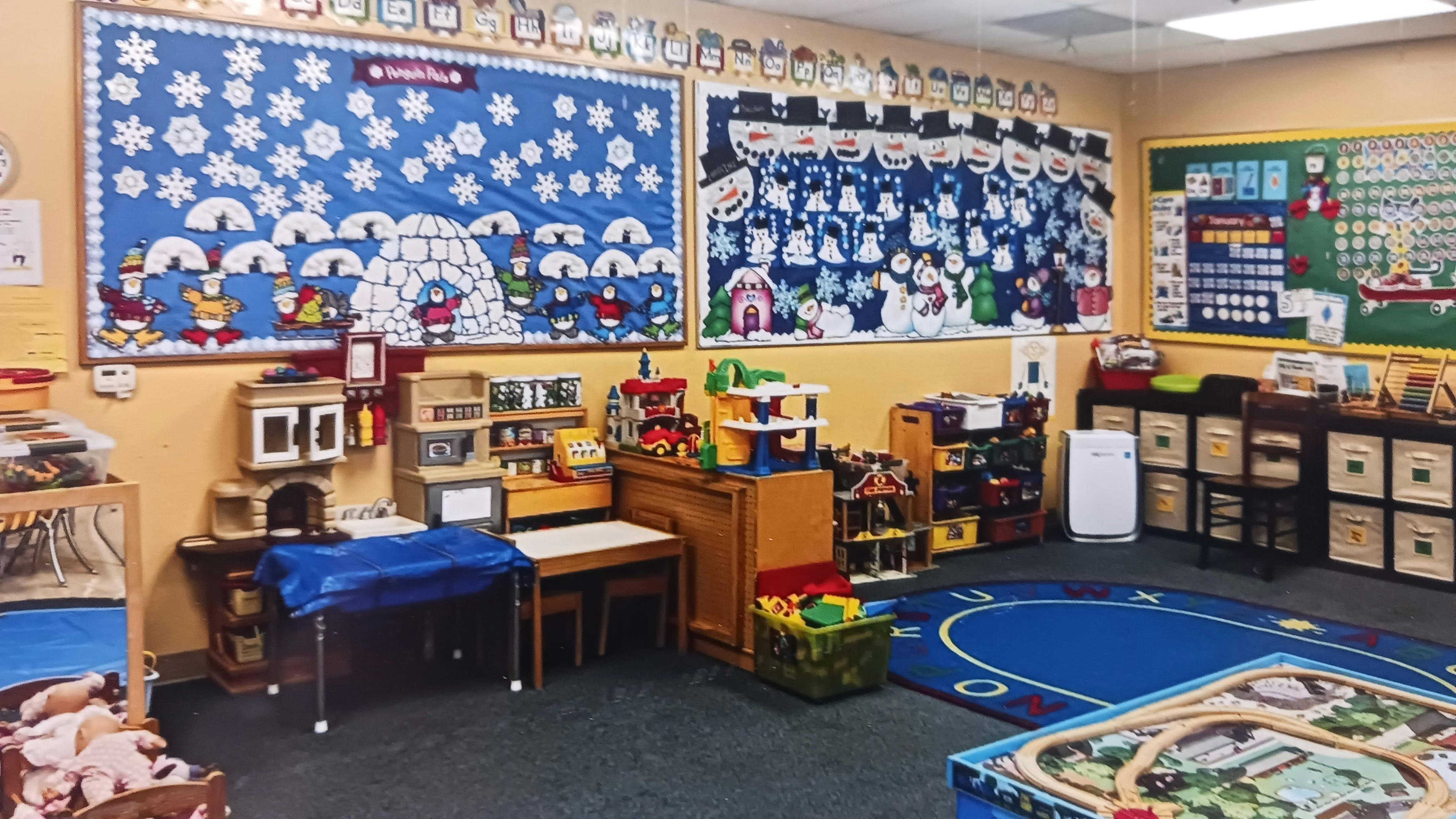 Classroom with winter-themed bulletin boards and play areas
